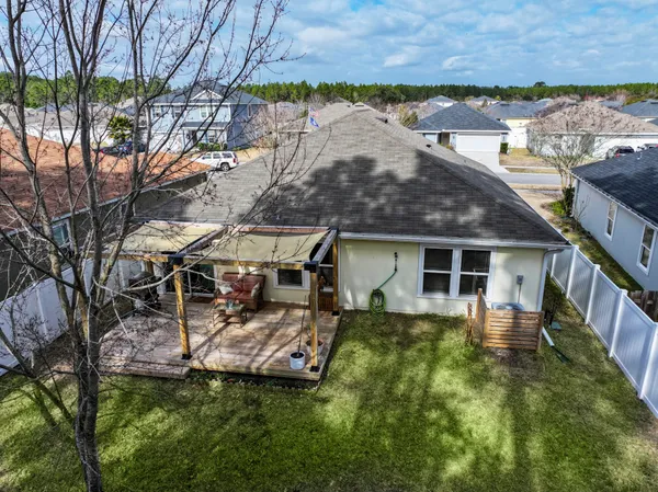 a view of a house with backyard and sitting area