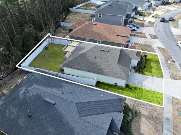 an aerial view of a house with a yard