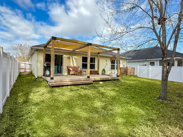 a view of a house with backyard and porch