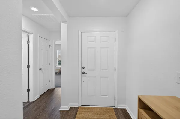 a view of a room with wooden floor