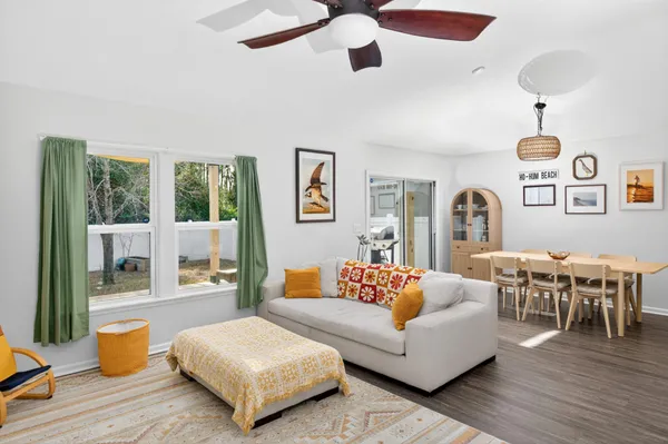 a living room with furniture and wooden floor