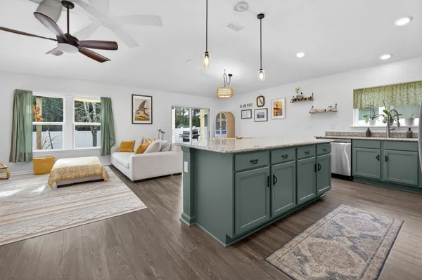a living room with furniture and a chandelier