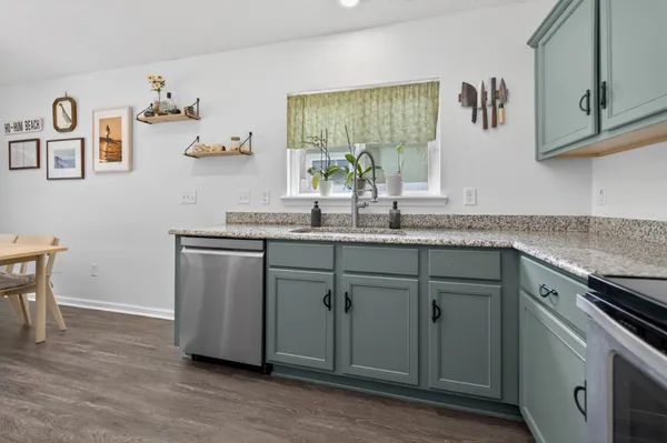 a kitchen with cabinets and window