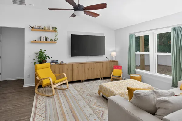 a living room with furniture and a flat screen tv