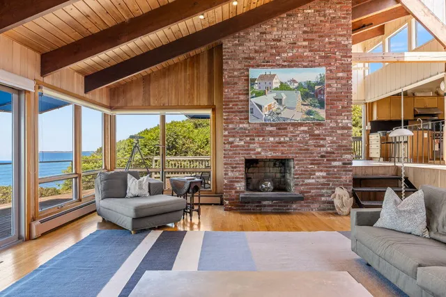 a living room with furniture a rug and a large window