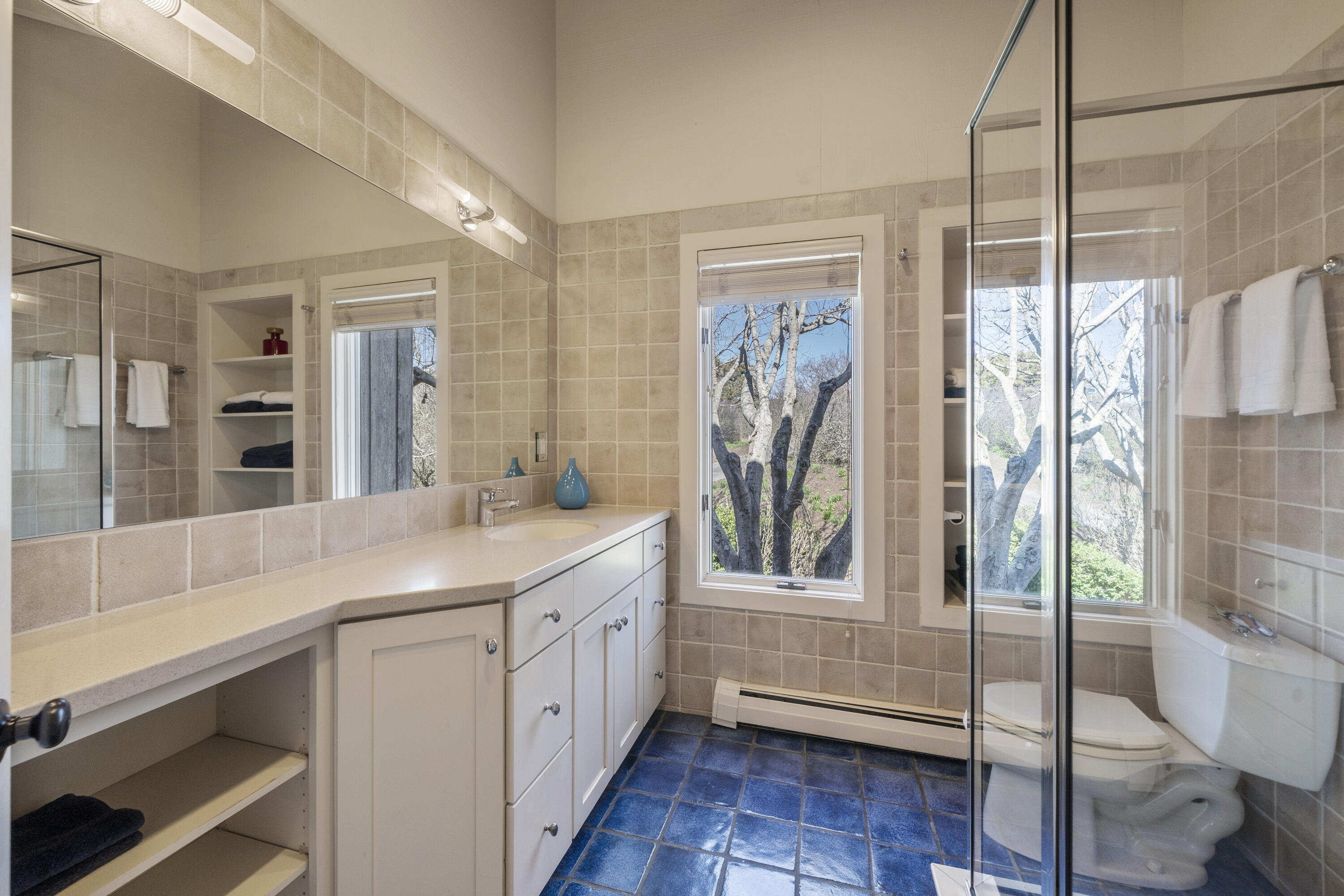 23 Crest View Circle Truro, MA 02666 - Photo 12 of 20 a bathroom with a double vanity sink a mirror a bathtub and next to a window