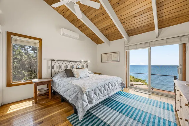 a bedroom with a bed and a flat tv screen on the dresser