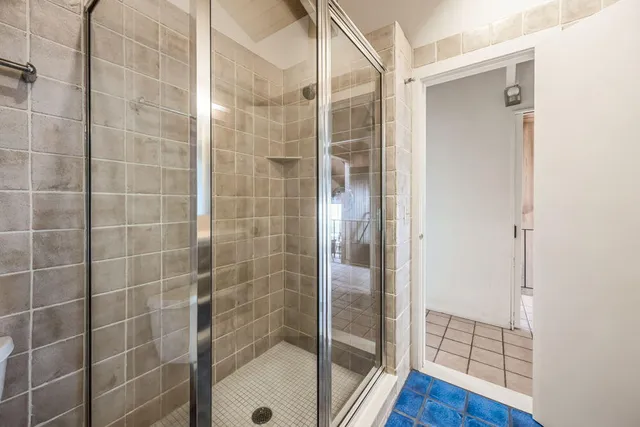 a bedroom with two beds and a large window