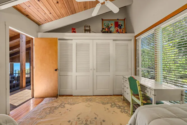 a bedroom with furniture and a window