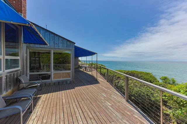 a view of chairs and table in the balcony