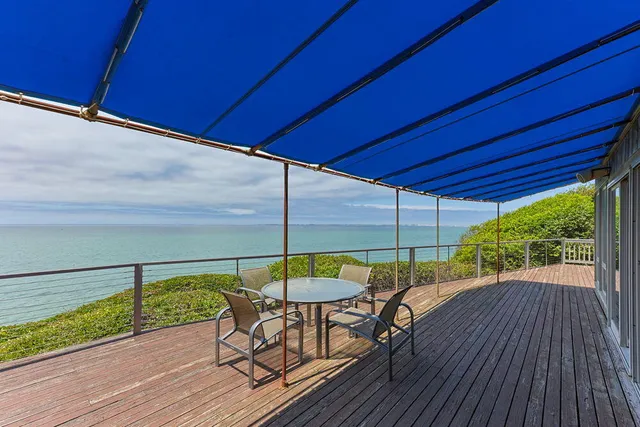 a backyard of a house with table and chairs