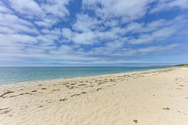an aerial view of a house with a yard and lake view