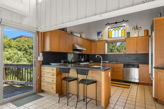 a kitchen with stainless steel appliances granite countertop a stove and a sink