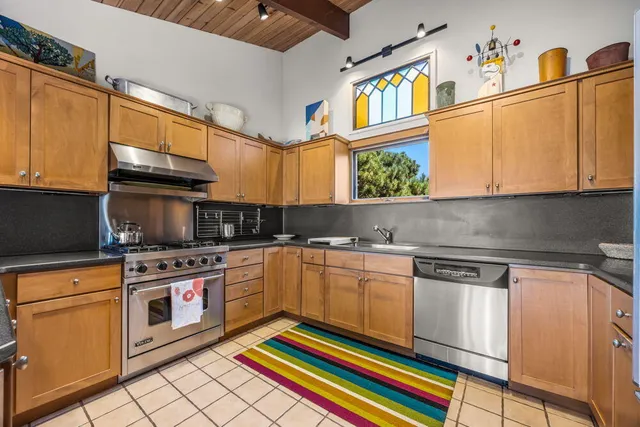 a kitchen with stainless steel appliances kitchen island granite countertop a sink and cabinets