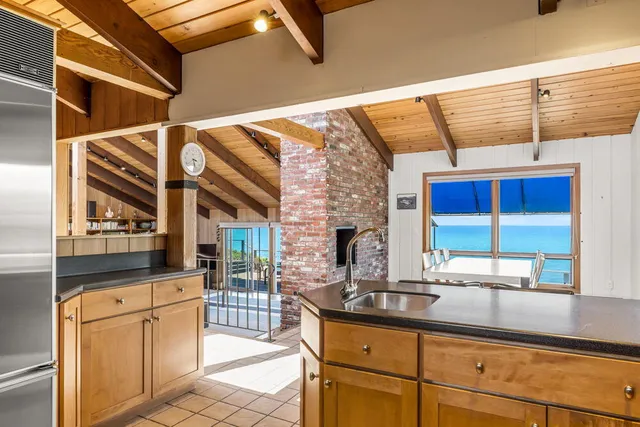 a view of a dining room with furniture and a window