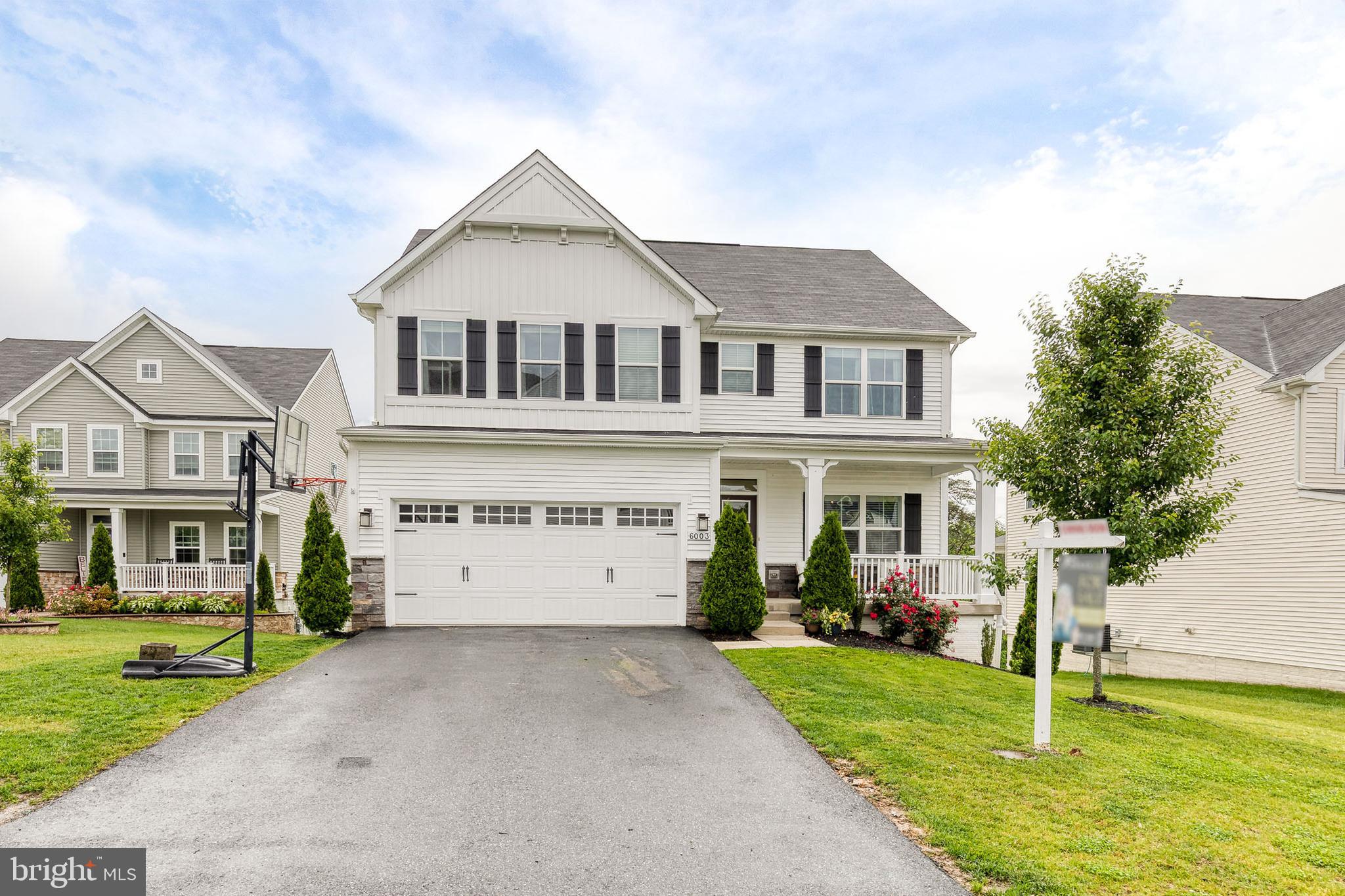 6003 Valentine Way Hanover, MD 21076 - Photo 1 of 52 a view of a white house with a big yard and large trees