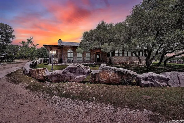 a view of a chairs and table in the backyard