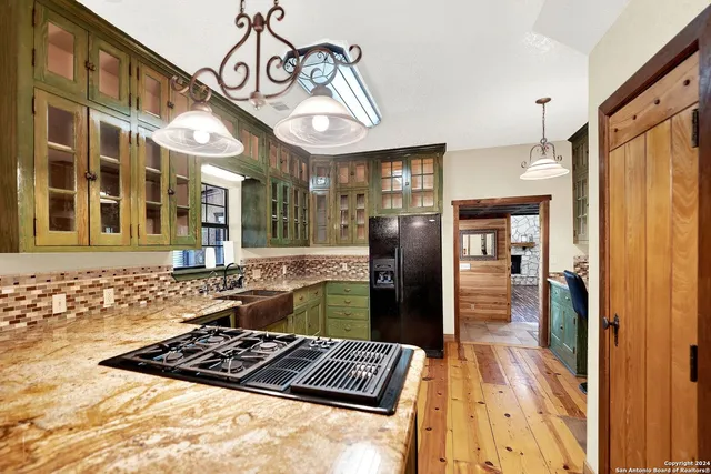 a kitchen with stainless steel appliances granite countertop a refrigerator and a stove