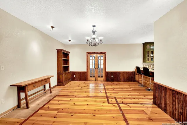 a bedroom with a large bed and a chandelier