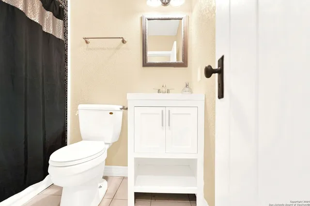 a white toilet sitting next to a bathroom sink