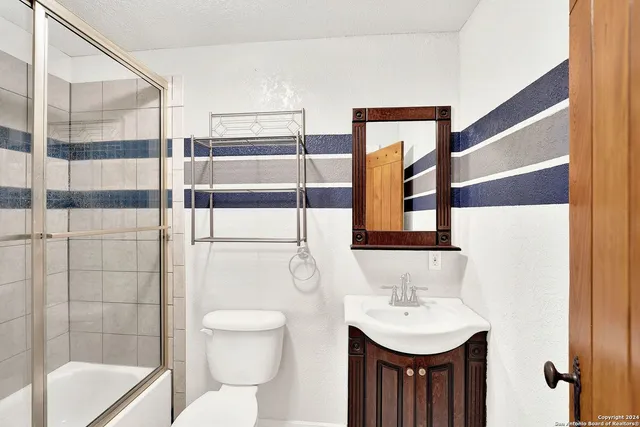 a bathroom with a sink toilet and shower