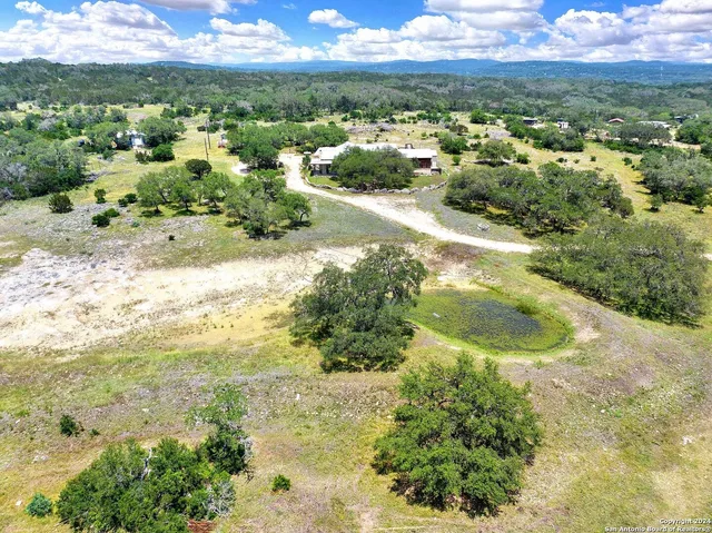 a view of a backyard with table and chairs under an umbrella