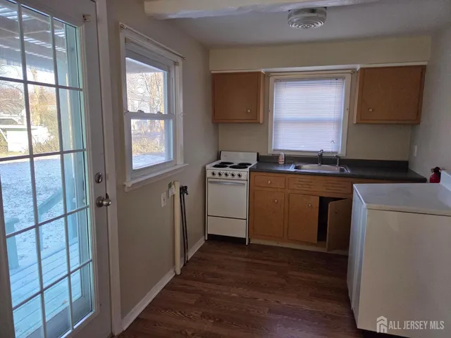 a kitchen with a stove a sink and a refrigerator