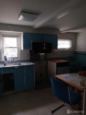 a kitchen with counter top space cabinets and appliances