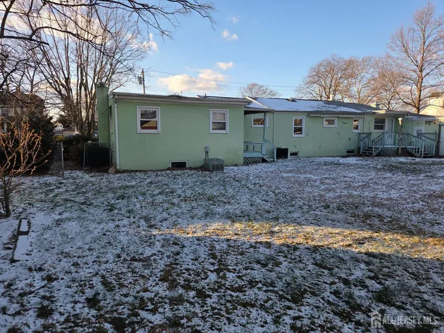 a view of a house with a backyard and trees
