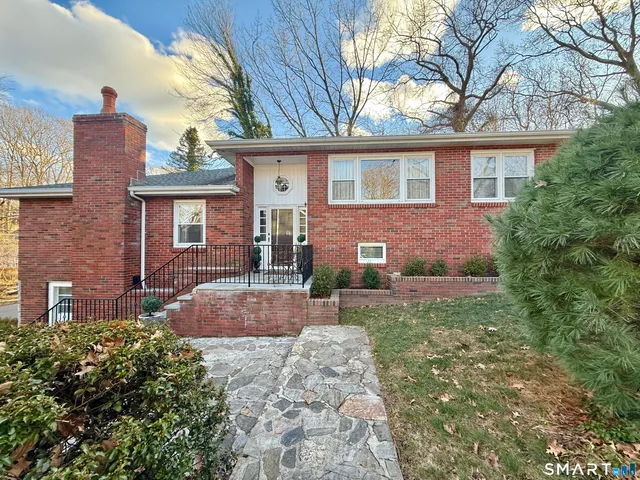a front view of a house with garden