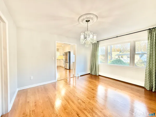 a large kitchen with cabinets and wooden floor