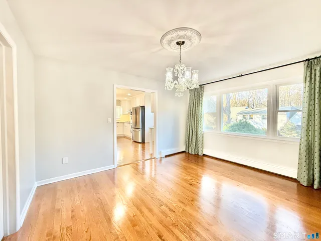 a large kitchen with cabinets and wooden floor