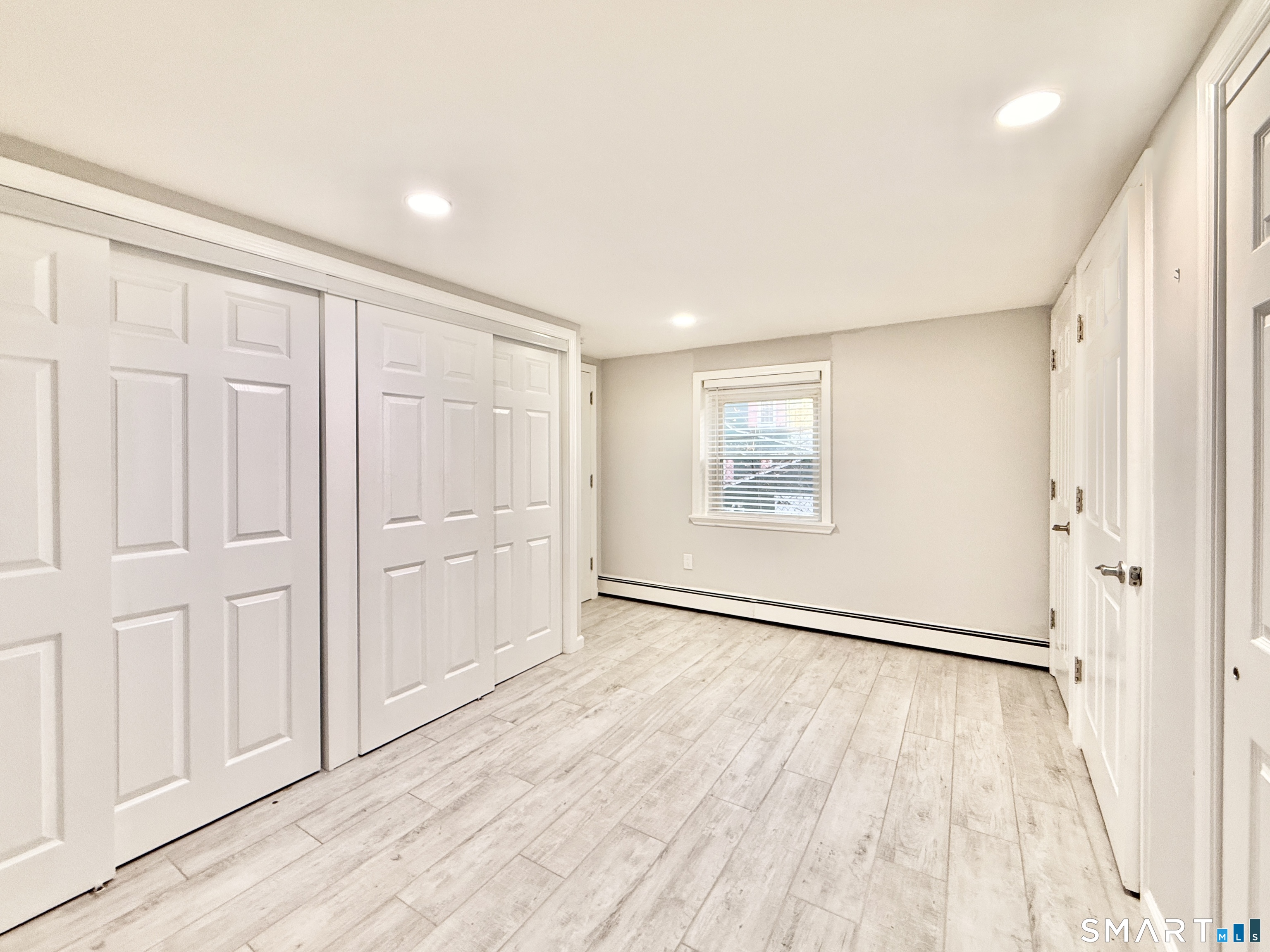 36 Center Drive Greenwich, CT 06870 - Photo 15 of 30 an empty room with wooden floor door and windows