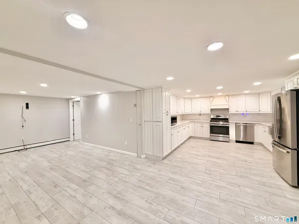 a kitchen with white cabinets and white appliances