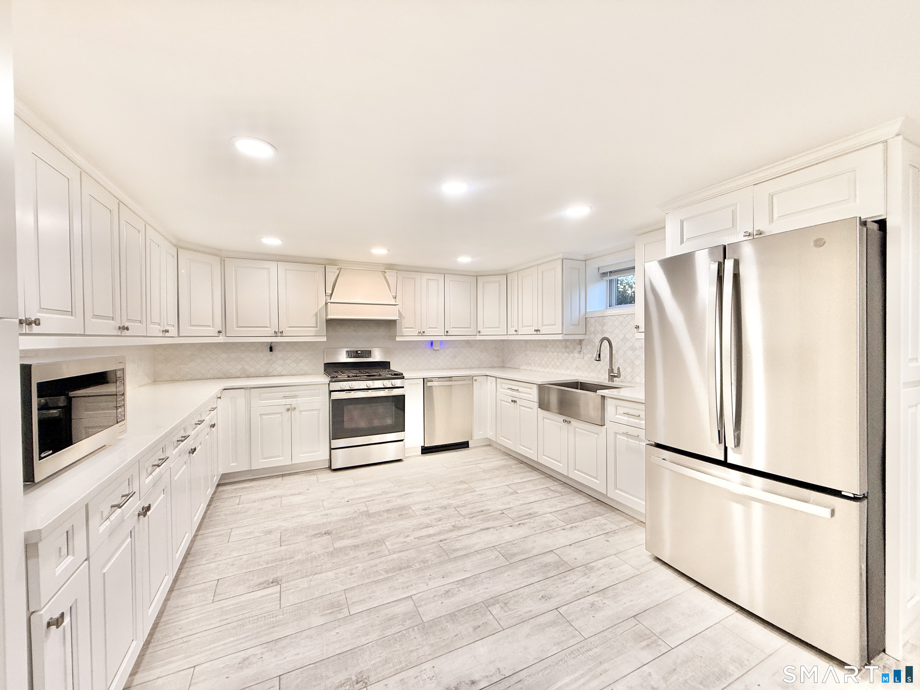 36 Center Drive Greenwich, CT 06870 - Photo 27 of 30 a kitchen with white cabinets and white appliances