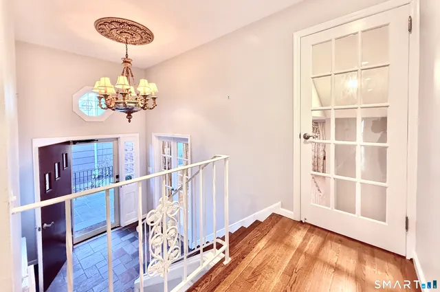 a view of an empty room with a fireplace and a window