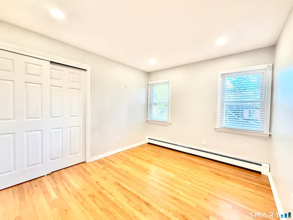 a bathroom with a sink mirror and shower