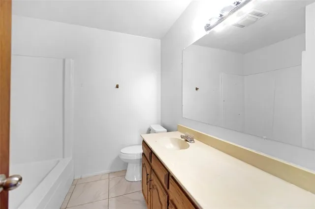 a bathroom with a sink a toilet and a bathtub