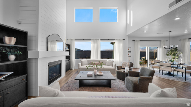 324 North Rhyolite Drive, Unit 87 Hurricane, UT 84737 - Photo 7 of 33 Living area featuring a large fireplace, wood finished floors, and a high ceiling