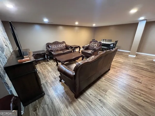 a living room with furniture and a flat screen tv