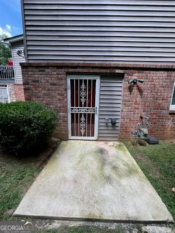 a view of a brick house with a yard