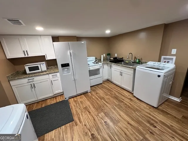 a kitchen with a sink refrigerator and microwave