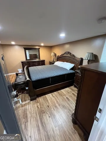 a bedroom with a bed and a tv