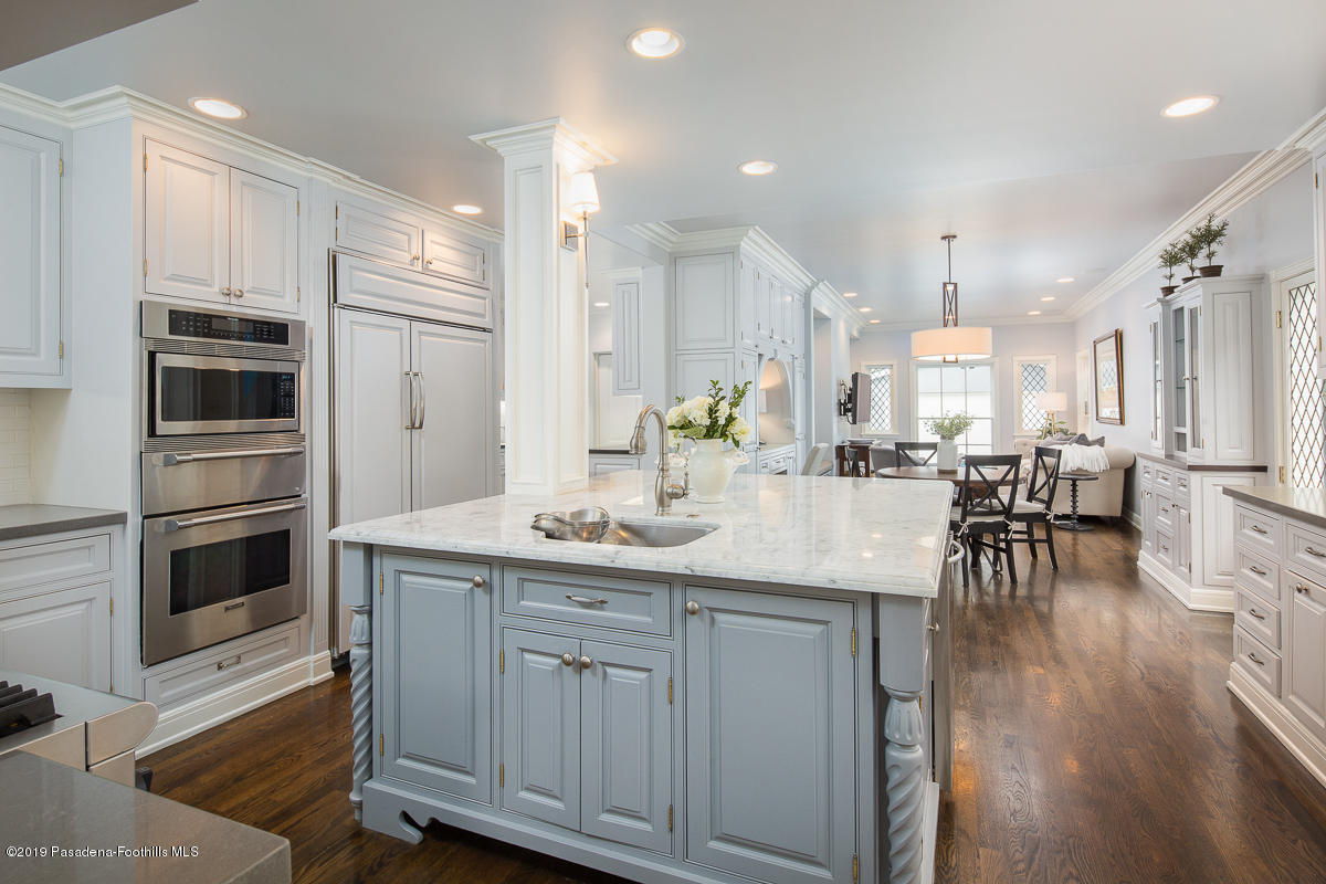 1590 Lombardy Road Pasadena, CA 91106 - Photo 26 of 85 a kitchen with kitchen island granite countertop a sink cabinets and stainless steel appliances