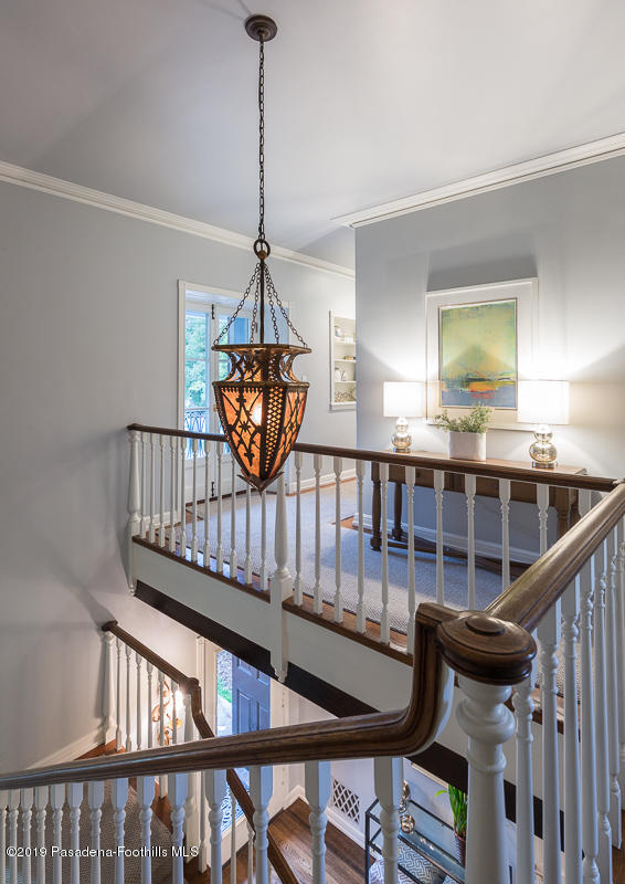 1590 Lombardy Road Pasadena, CA 91106 - Photo 62 of 85 a view of staircase with a table and a chandelier
