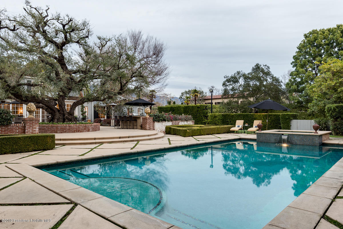 1590 Lombardy Road Pasadena, CA 91106 - Photo 74 of 85 a view of a swimming pool with chairs in patio