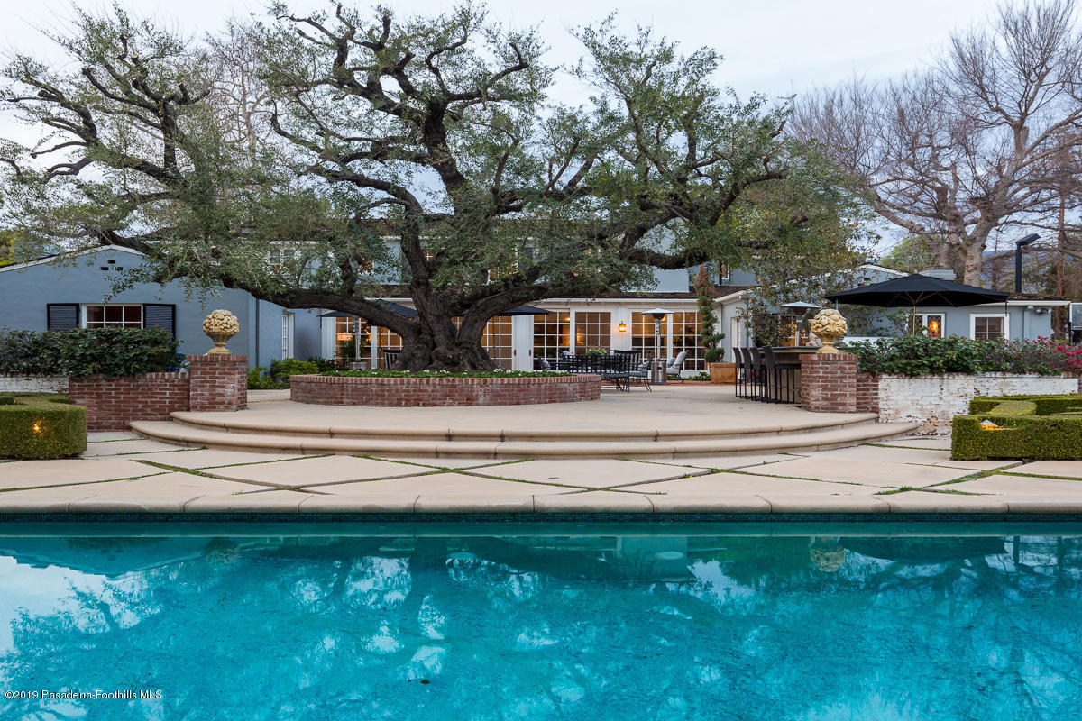 1590 Lombardy Road Pasadena, CA 91106 - Photo 75 of 85 a view of swimming pool with outdoor seating and house in the background