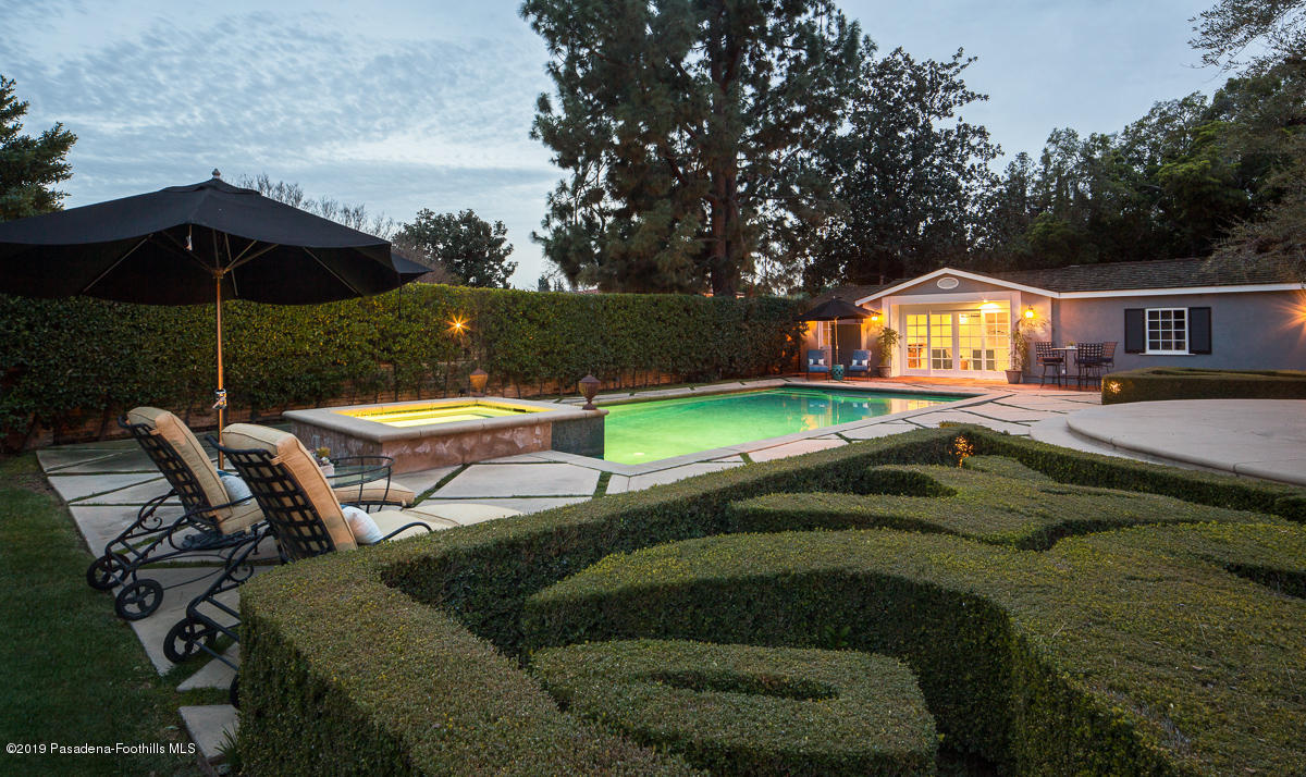 1590 Lombardy Road Pasadena, CA 91106 - Photo 80 of 85 a backyard of a house with table and chairs under an umbrella