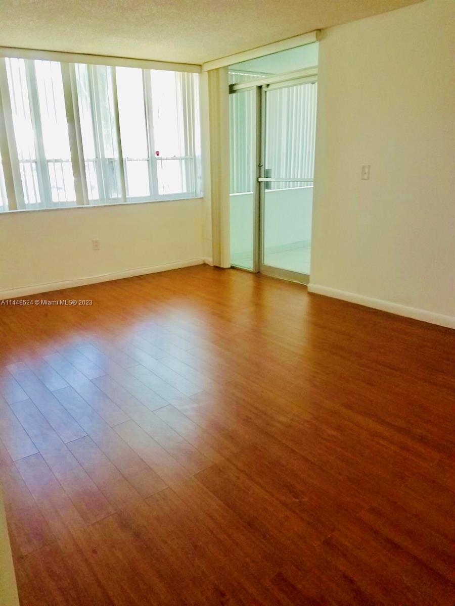 6801 Southwest 147th Avenue, Unit 1E2 Miami, FL 33193 - Photo 1 of 15 a view of empty room with wooden floor and fan