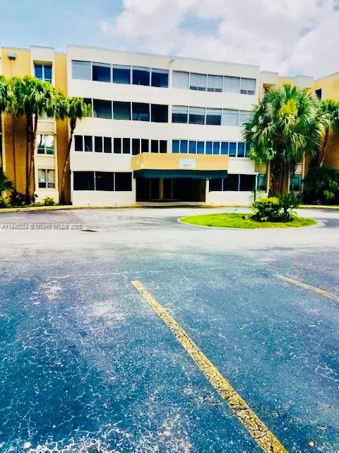 6801 Southwest 147th Avenue, Unit 1E2 Miami, FL 33193 - Photo 13 of 15 a view of a building with a garden and trees